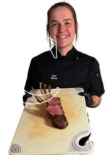 Chef with plated steak dish