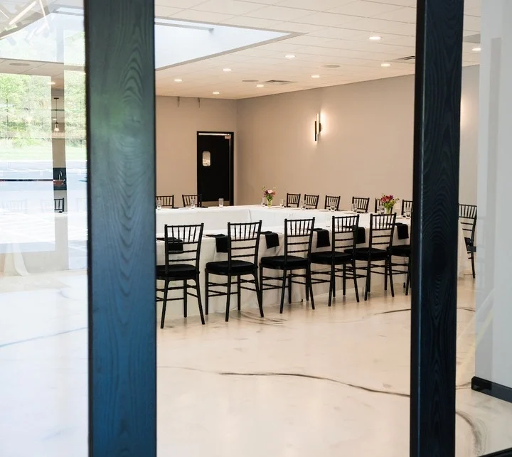 Meeting room rental in Fallston, MD with a large table, chairs, and presentation board.