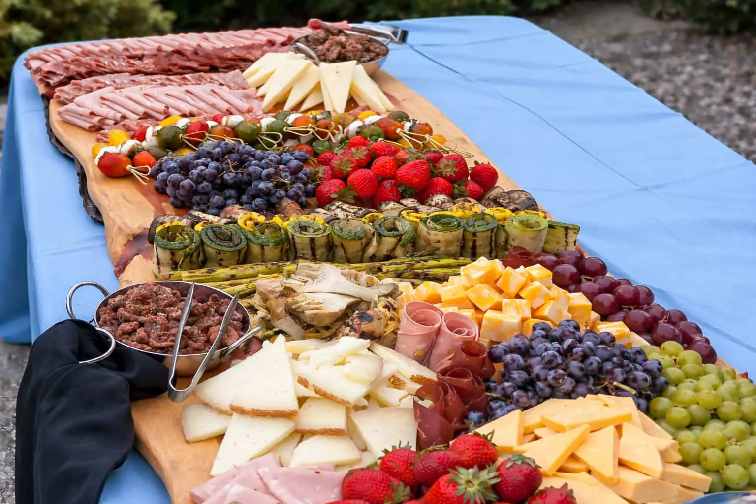 Large charcuterie board with cheeses, cured meats, fruit, and caprese skewers prepared for hors d'oeuvres catering in Baltimore, MD